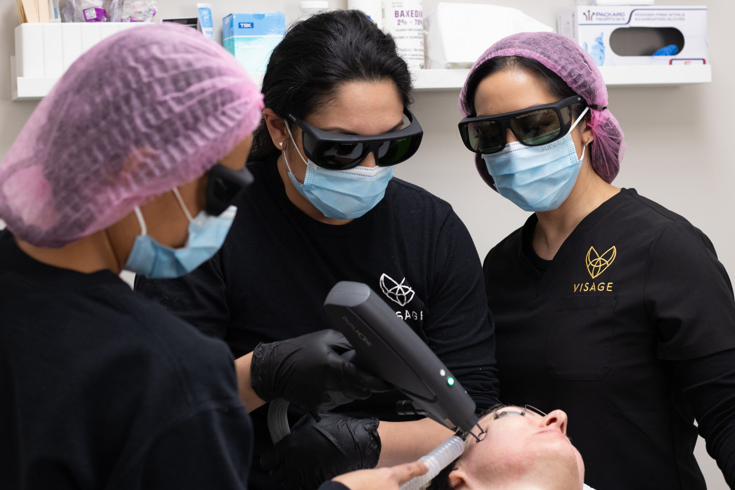Laser techs apply an IPL photofacial laser to a patient's face.