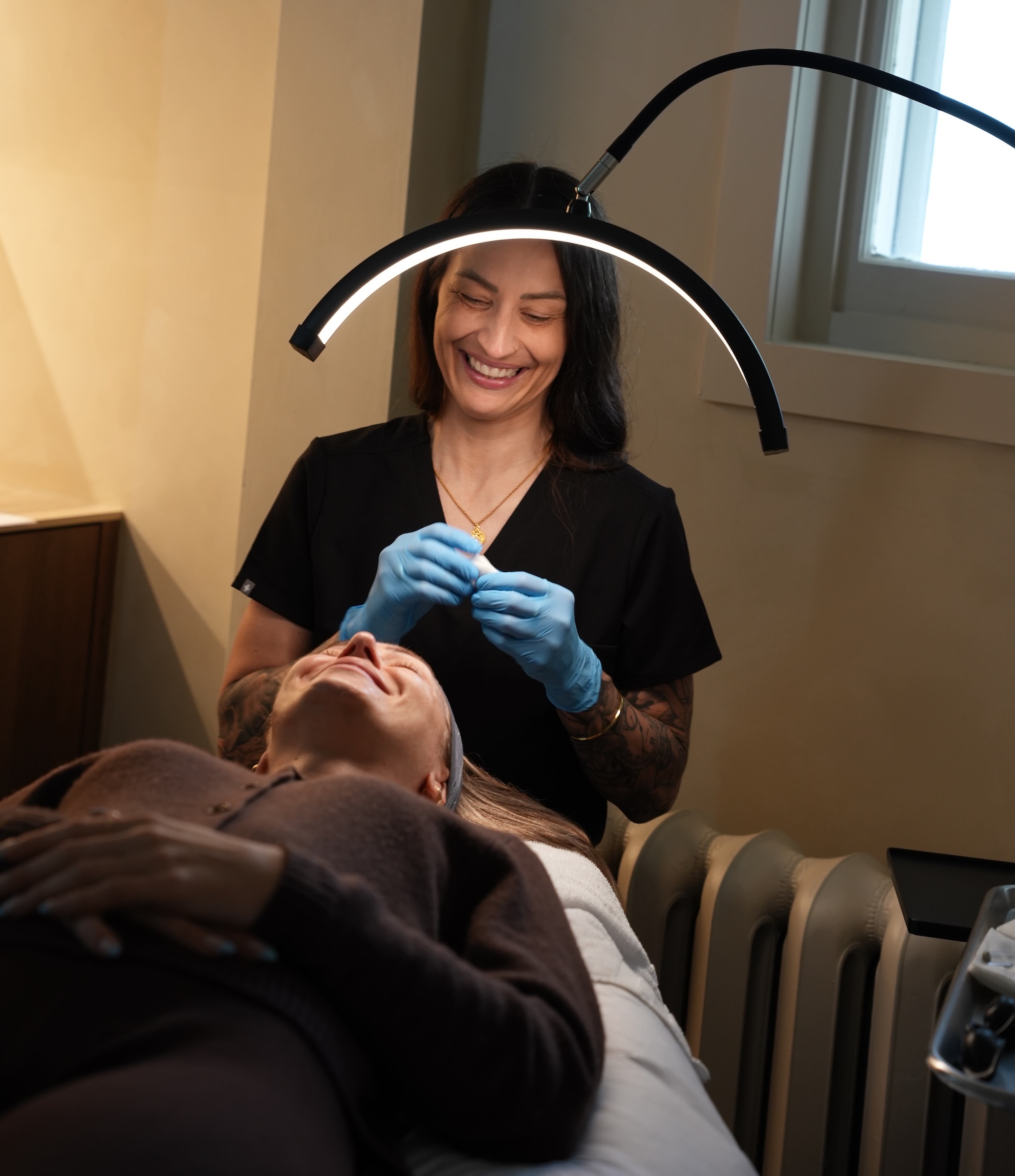 A medical aesthetician prepares a facial peel for a patient.